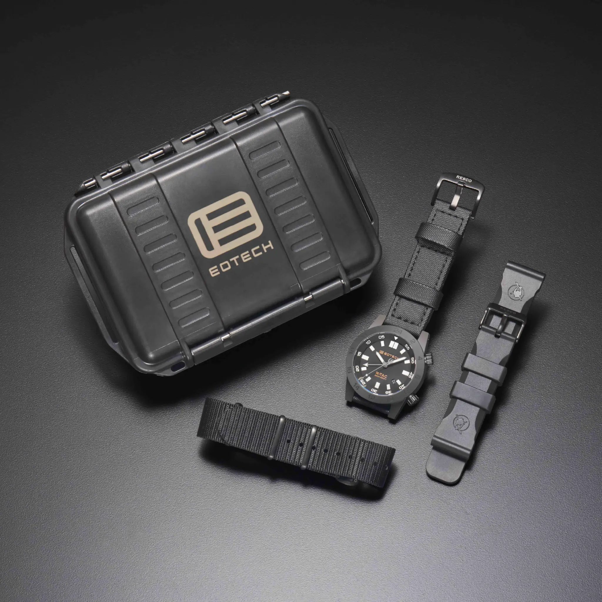 Black watch with straps and EOTECH case on a dark gray background