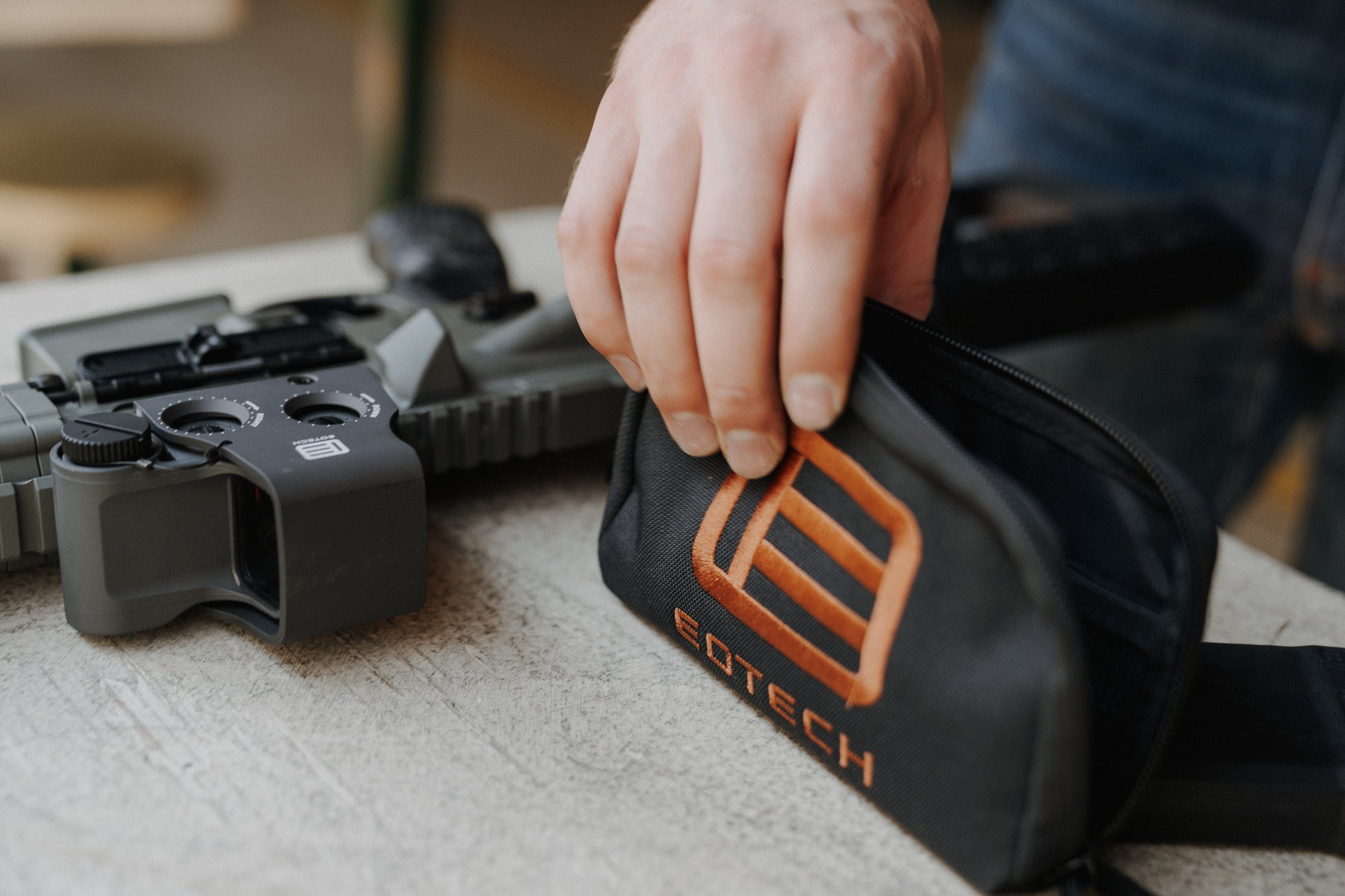 Eotech fix it sticks with a hand interacting with it on a surface