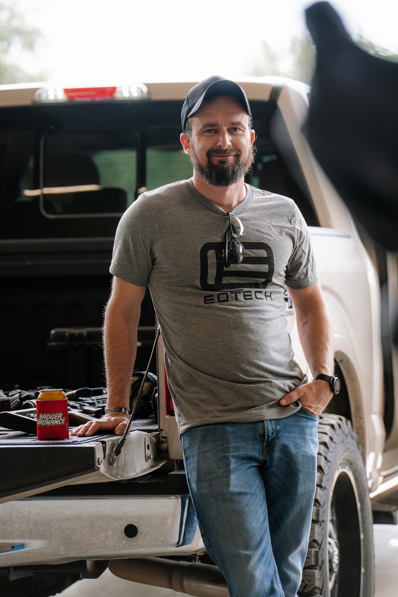 Man standing next to a truck wearing a gray t-shirt with EOTECH logo.