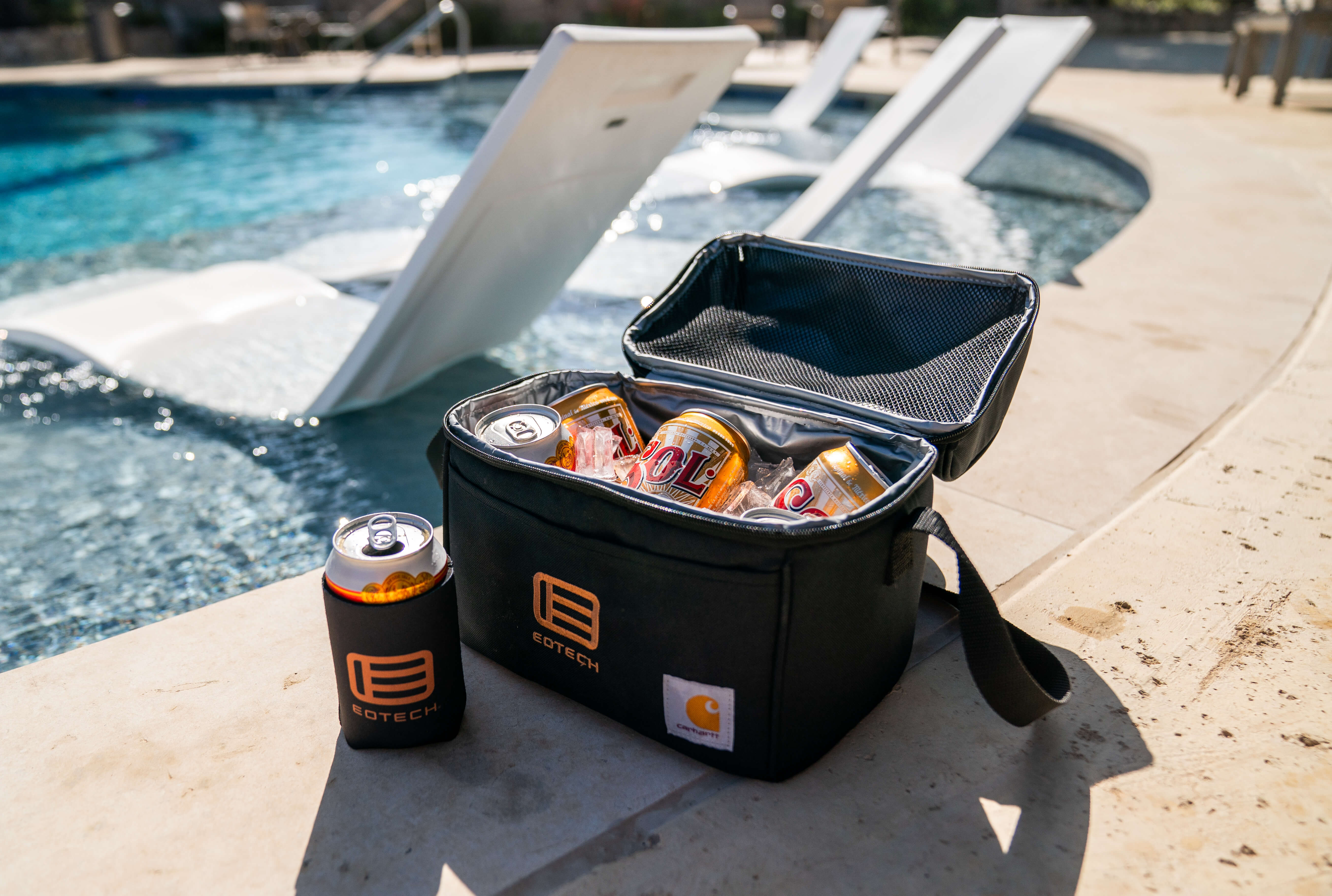 Black EOTECH cooler bag with drinks by a pool