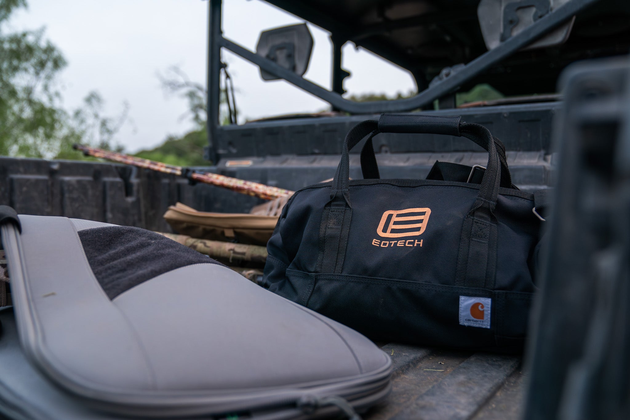 Black EOTECH duffel bag on a vehicle's open door