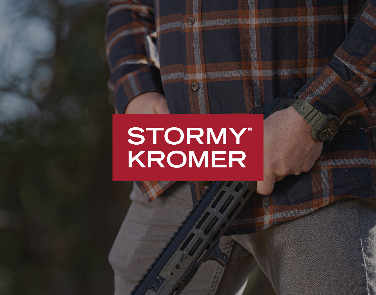 Person holding a rifle with 'Stormy Kromer' logo in the corner