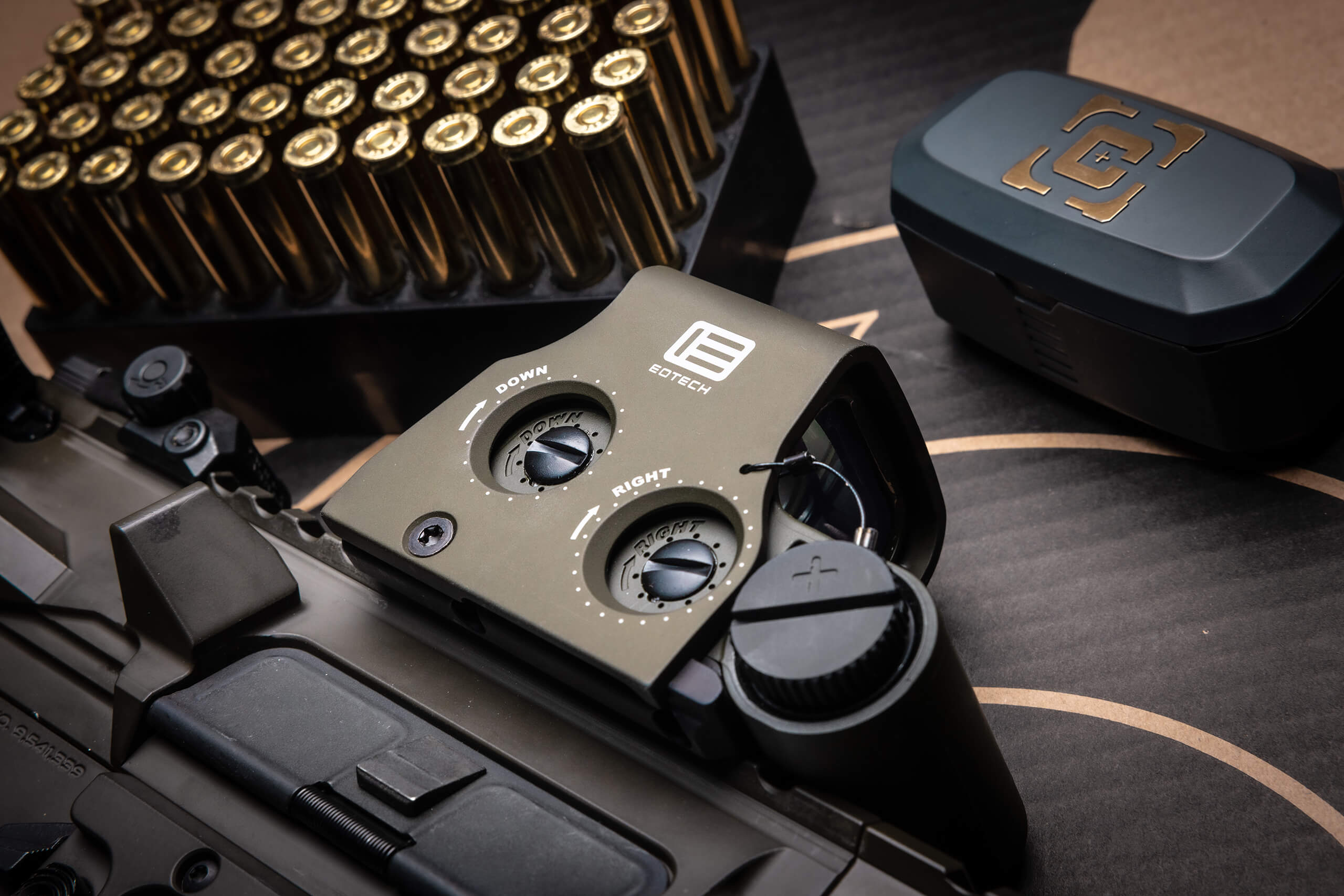 Close-up of a hws optic with ammunition on a target