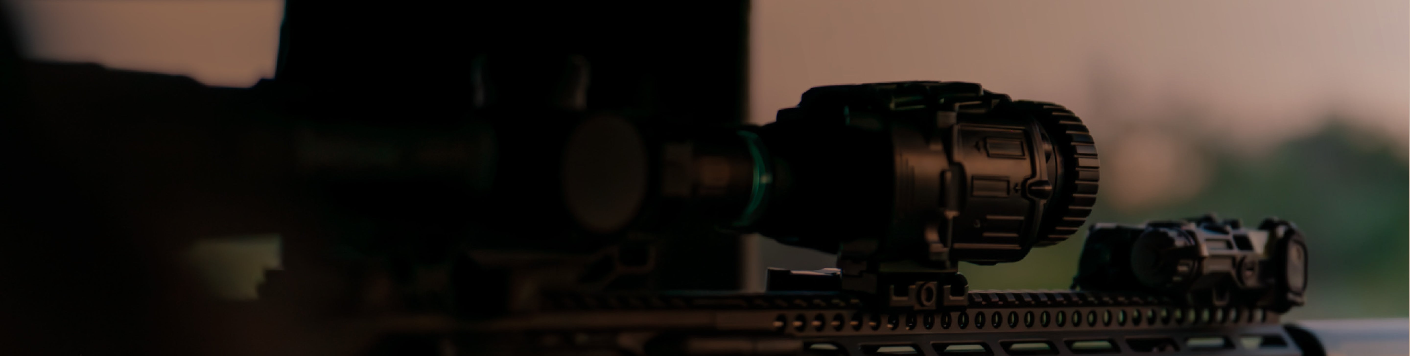 Close-up of a riflewiht black EOTECH Vudu scope, Clipon and OGL with a blurred background