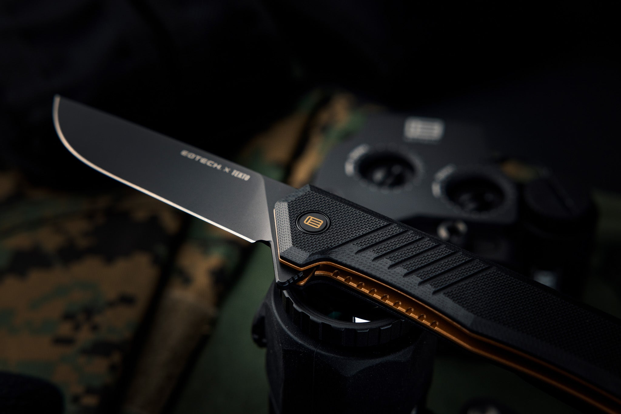 EOTECH Folding knife with a black blade and black handle on a dark background