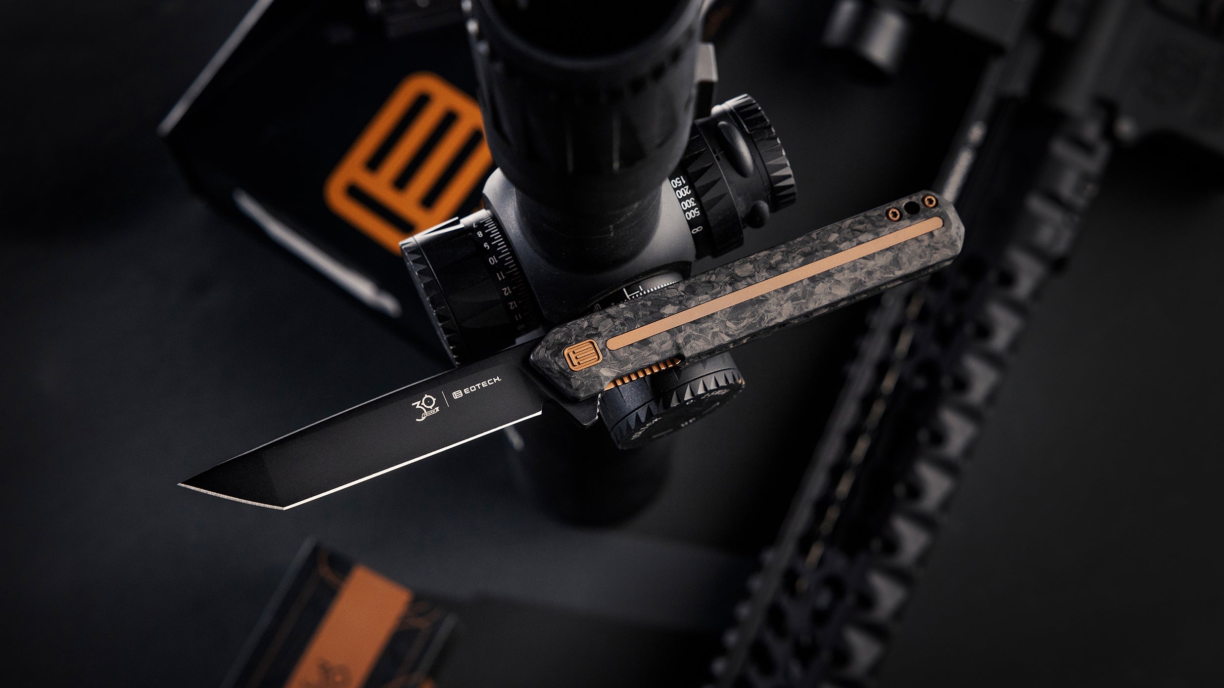 EOTECH Folding knife with a copper and black handle on a dark background