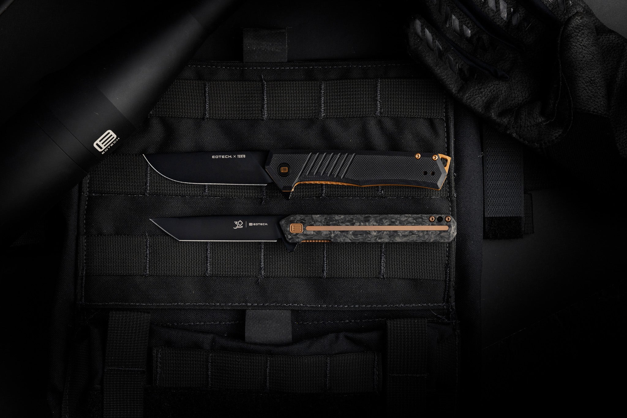 Two Black EOTECH tactical knives on a black background