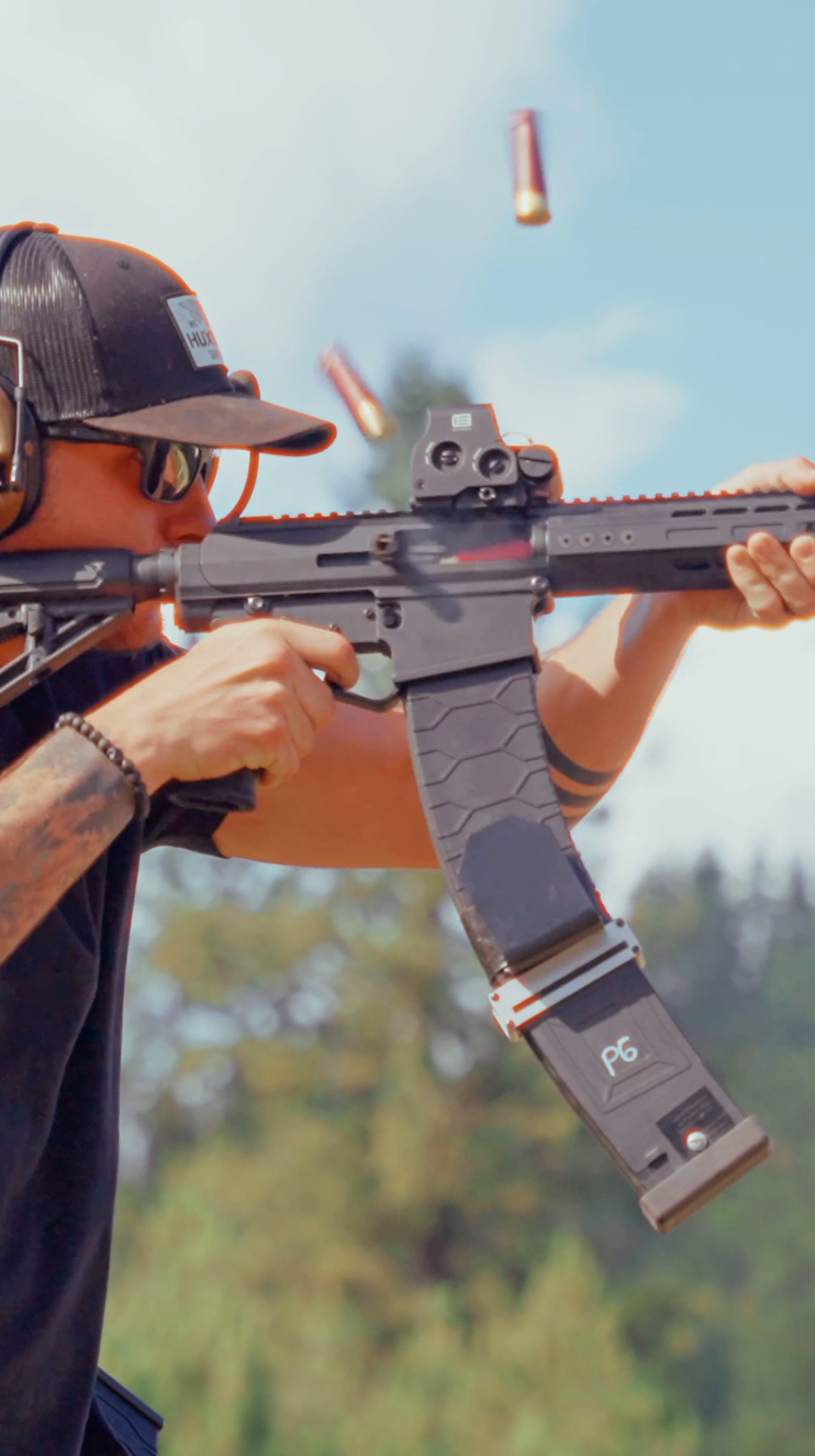 Person holding a shotgun with EOTECH HWS black, with blurred background