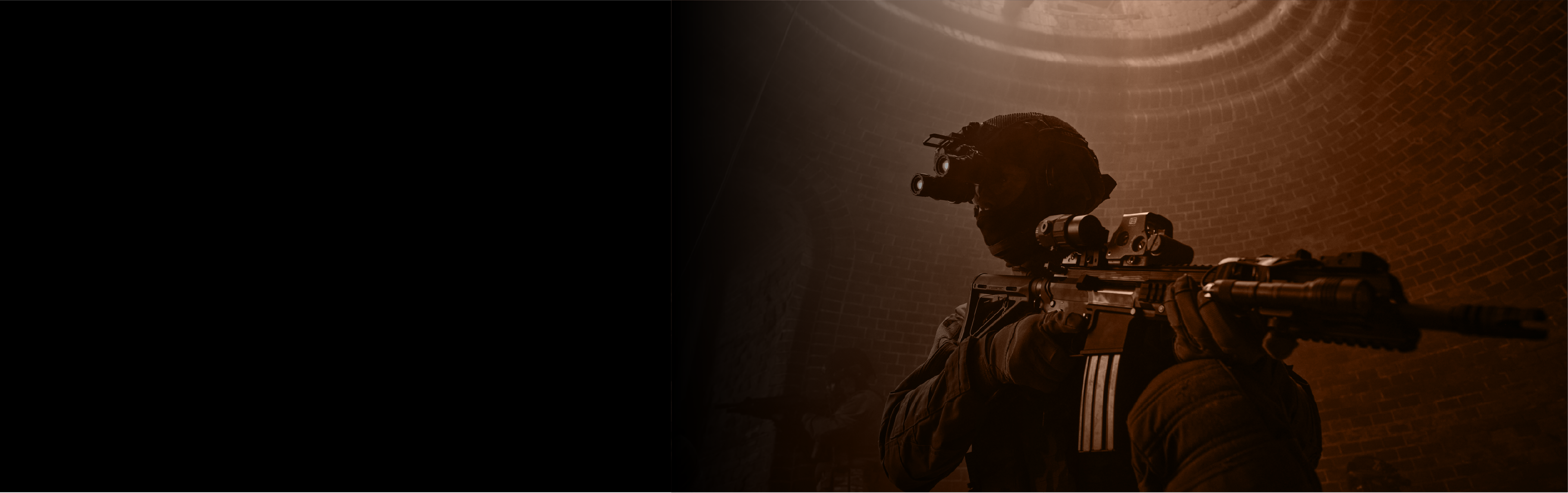Silhouette of a person holding rifle with EOTECH Has optic and magnifier in a dark setting