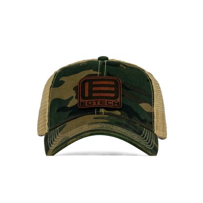 A camouflage trucker hat with tan mesh back panels and a brown rectangular patch on the front featuring the EOTECH logo.