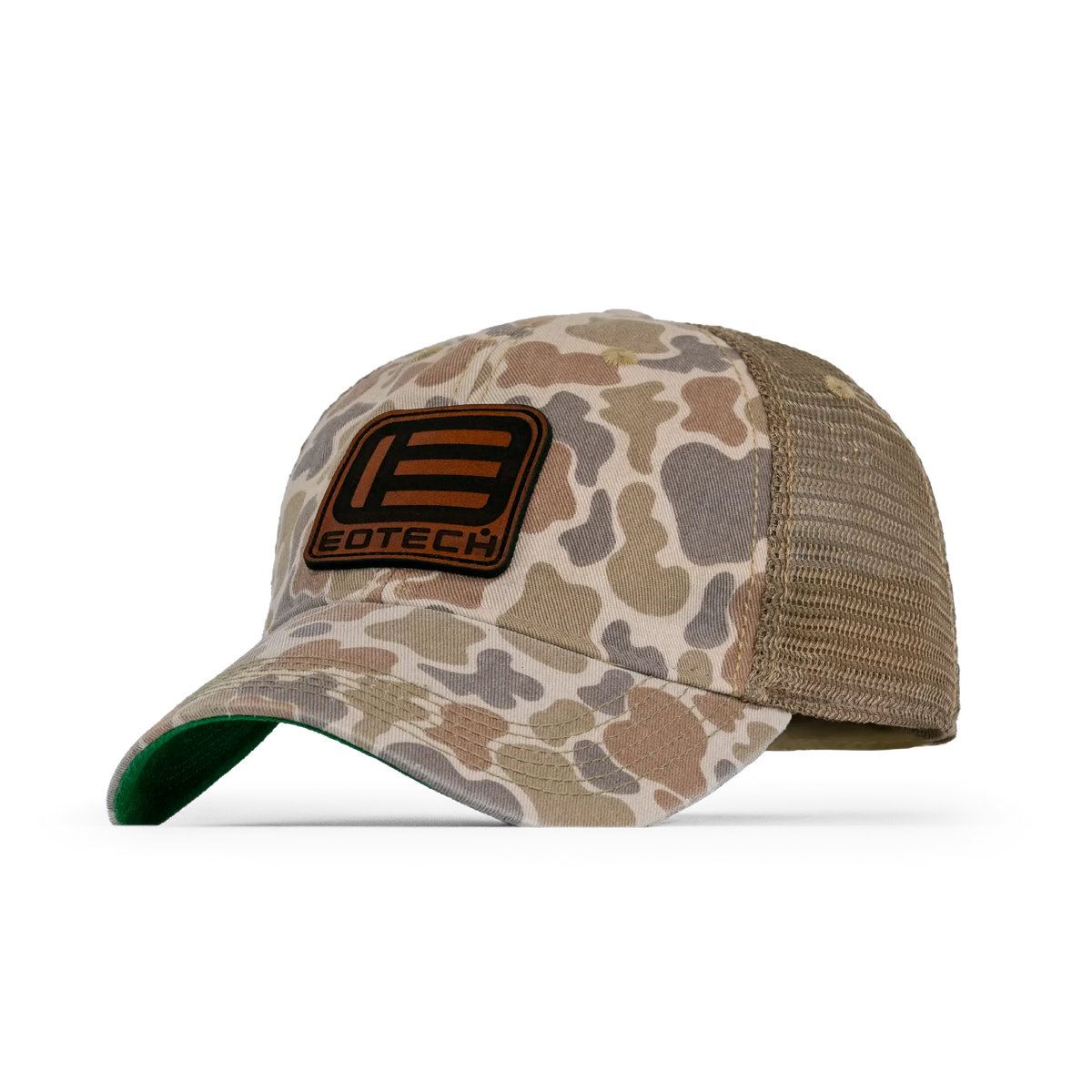 A duck camouflage trucker hat with tan mesh back panels and a brown leather patch on the front featuring the EOTECH logo from an angle.