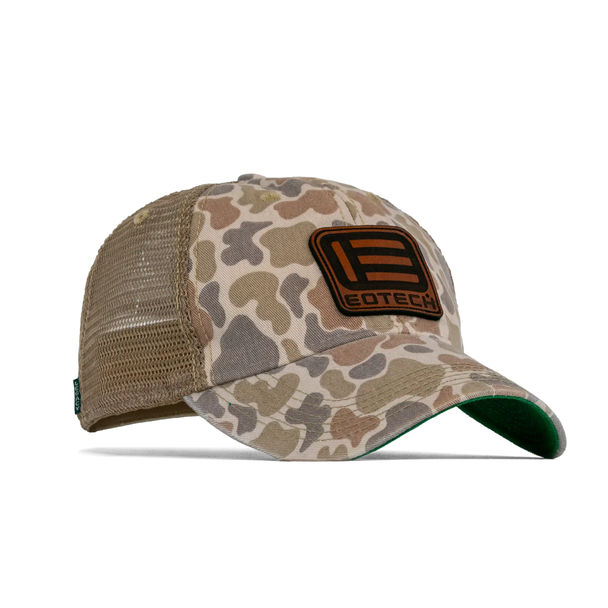 A duck camouflage trucker hat with tan mesh back panels and a brown leather patch on the front featuring the EOTECH logo from an angle.