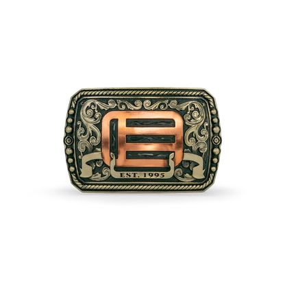 An ornate western-style belt buckle with gold-toned metal edges, and copper-toned EOTECH logo and scrollwork on a white background.
