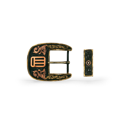 An ornate western-style belt buckle with gold-toned metal edges, and copper-toned scrollwork and geometric details, shown alongside its matching keeper on a white background.