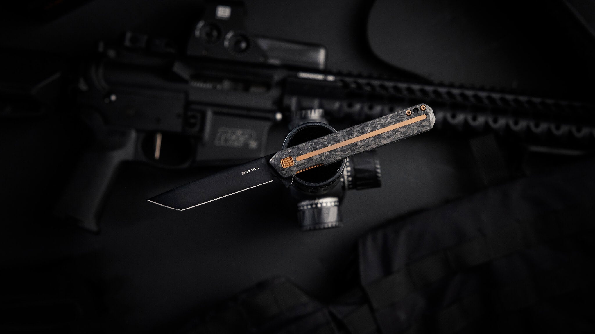 Knife balanced on a scope on a dark background