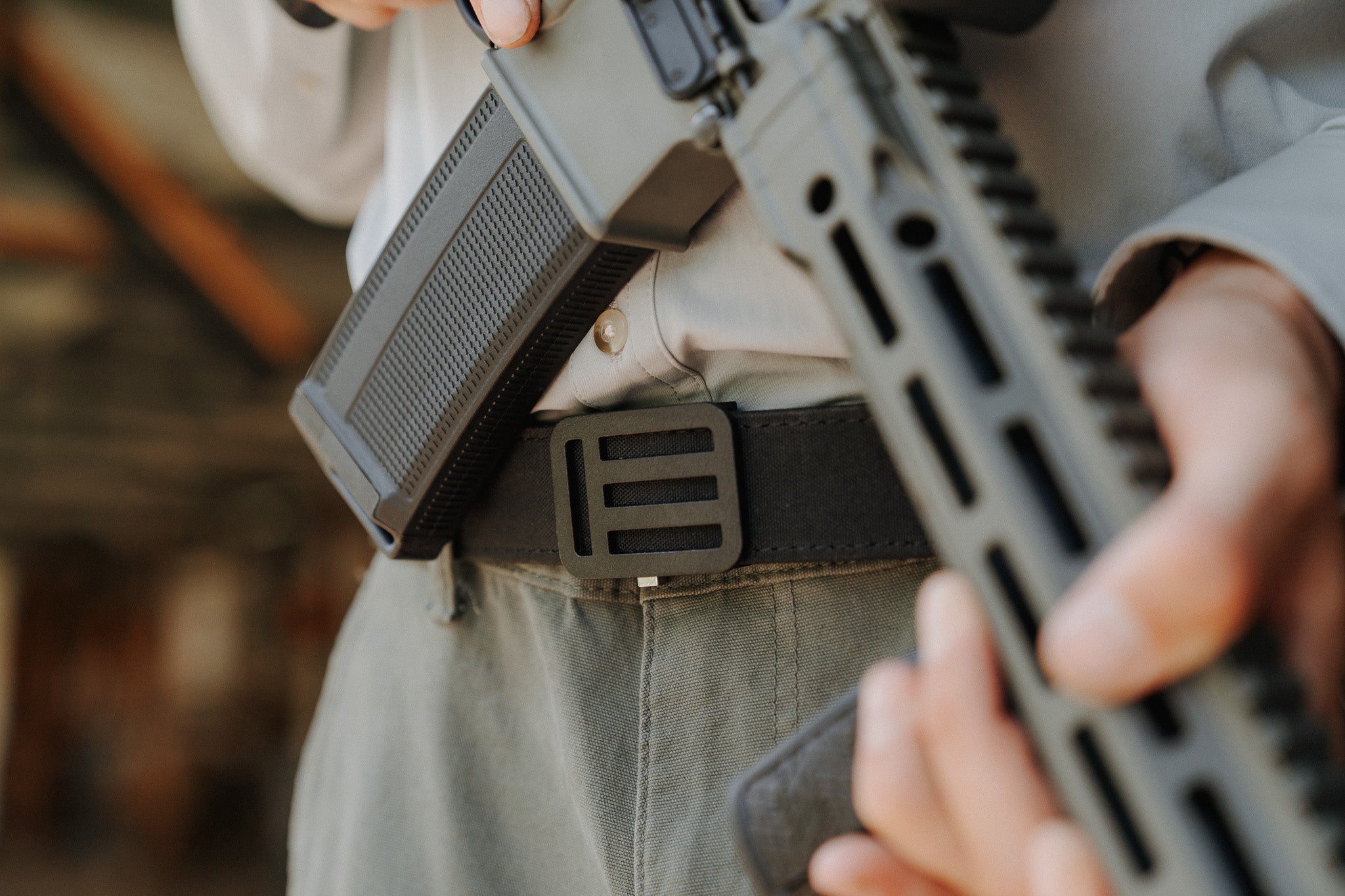 Person wearing the black EOTECH EDC belt in an indoor range