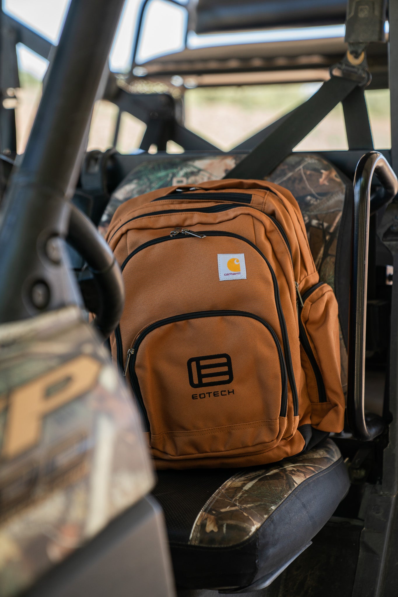 Brown EOTECH backpack on a vehicle seat