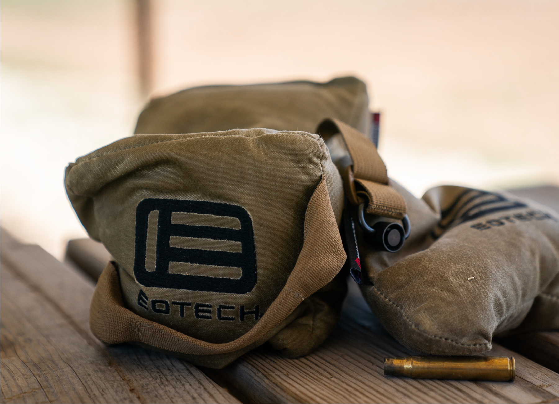 Brown EOTECH bench bags on a wooden surface