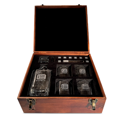 Set of glassware with a decanter and four glasses in a wooden box on a white background