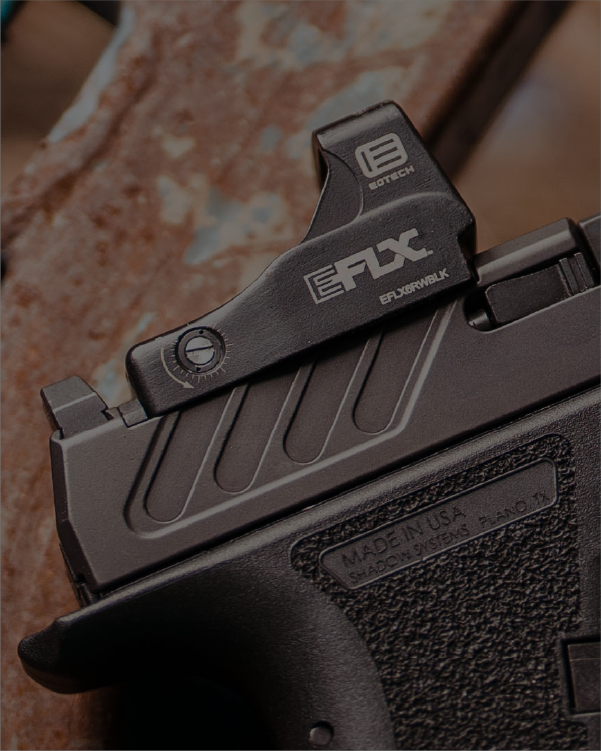 Close-up of a gun with EOTECH EFLX red dot optic on a blurred background