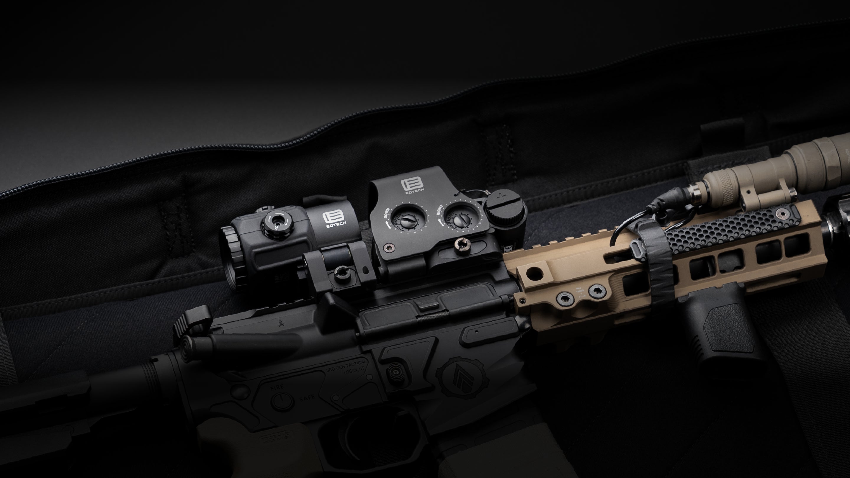 Weapon with a mounted EOTECH HHS optic and light on a dark background