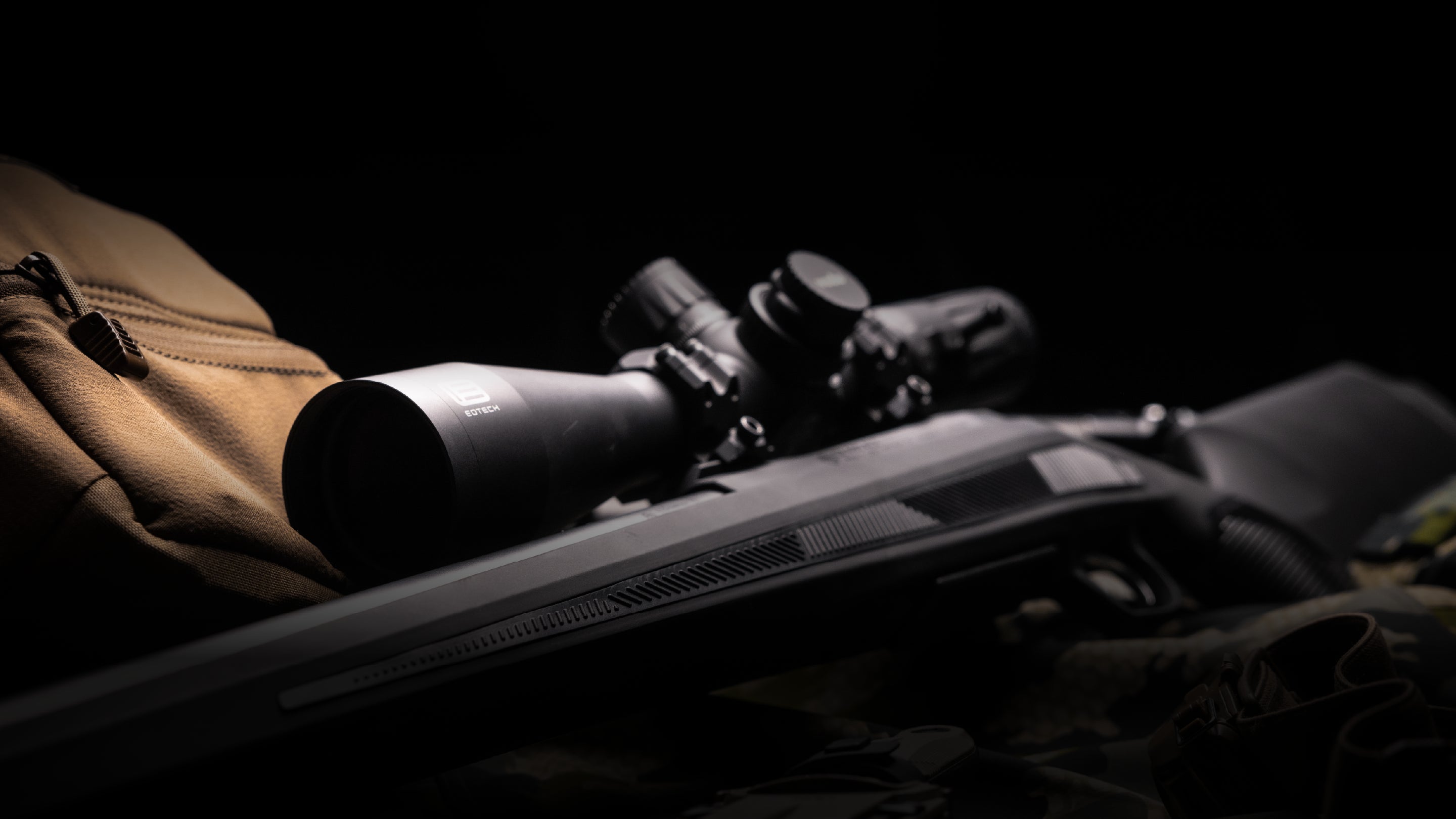 Close-up of a rifle with a EOTECH Vudu  scope on a dark background