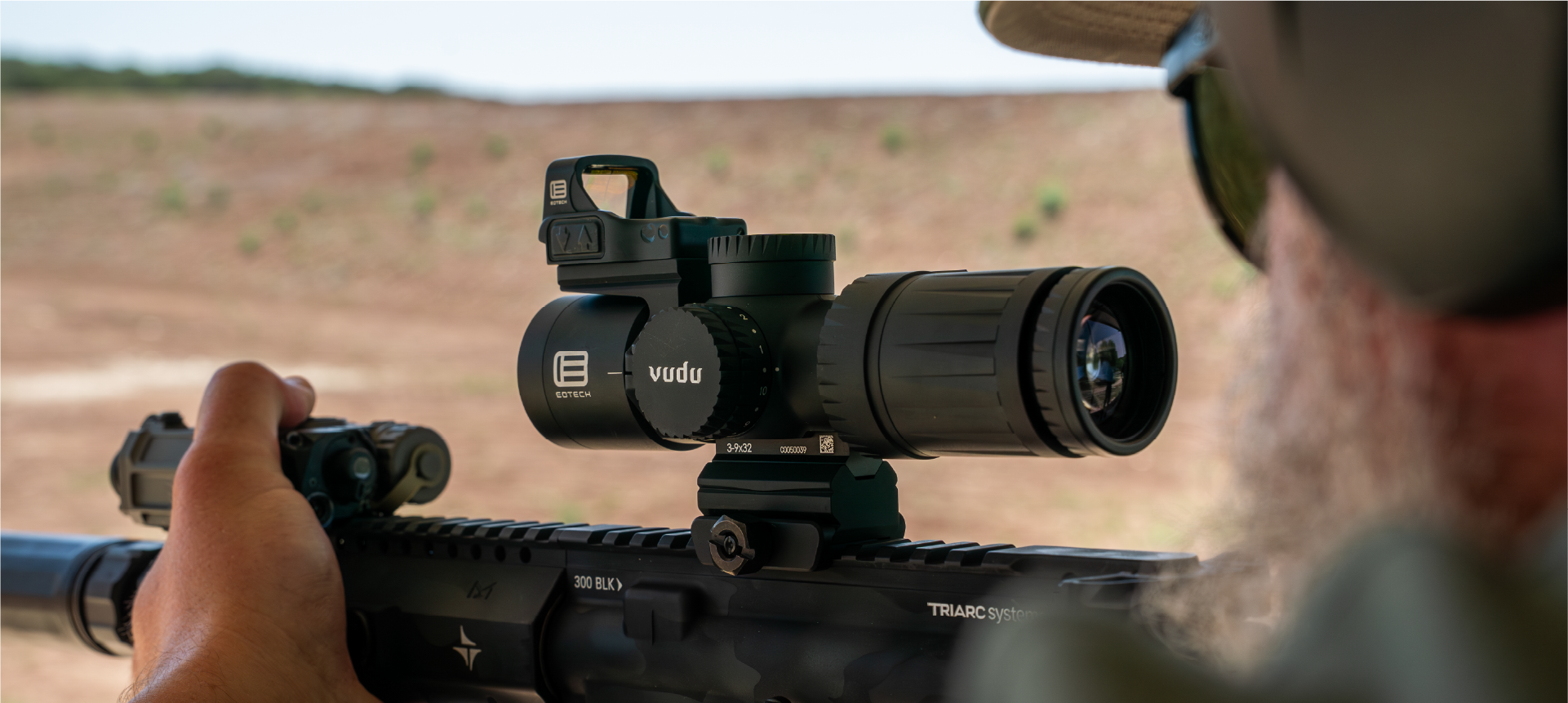 Person using a rifle with a EOTECH Vudu scope in an outdoor setting