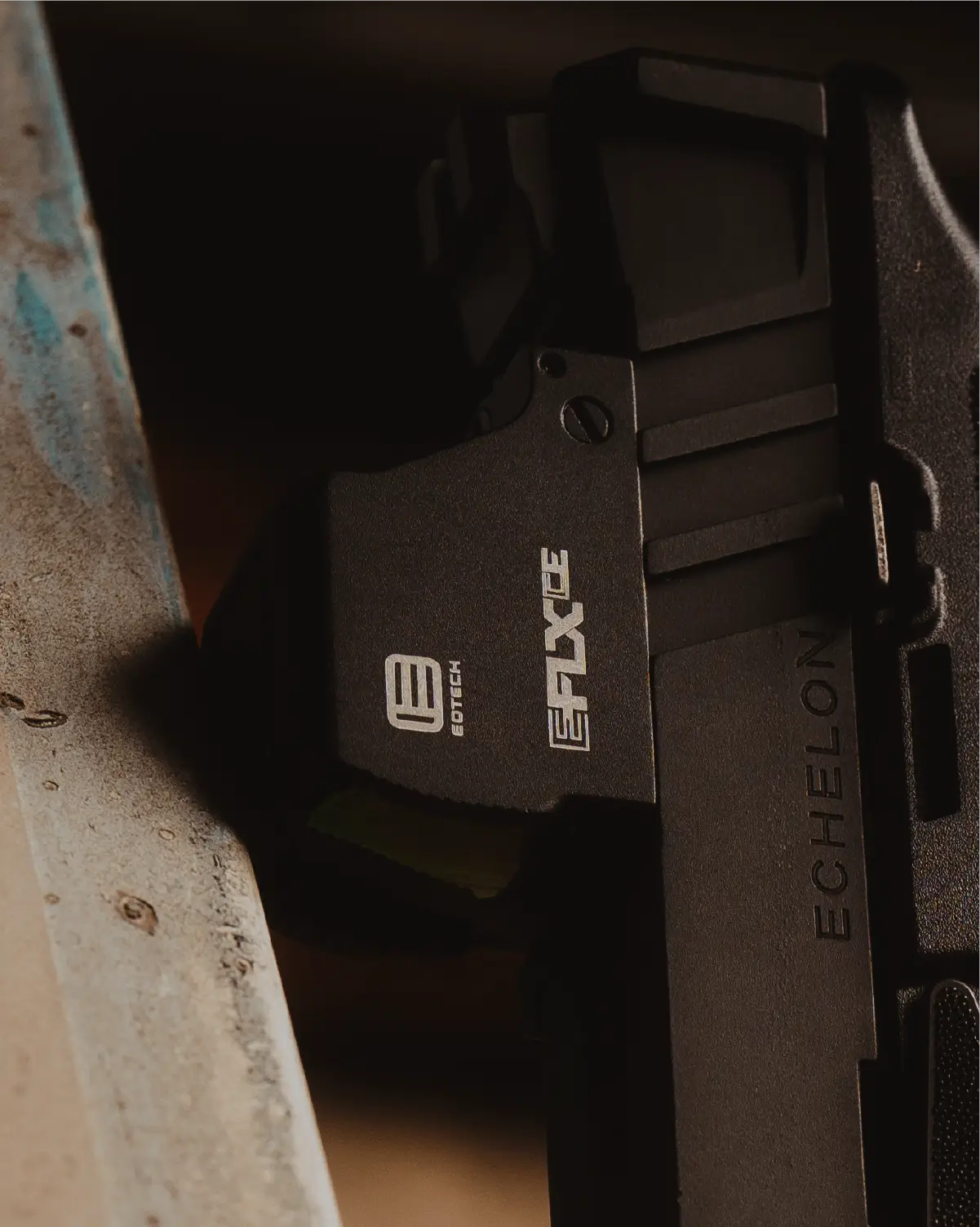 Close-up of a black firearm with EFLX branding  on a the pistol optic
