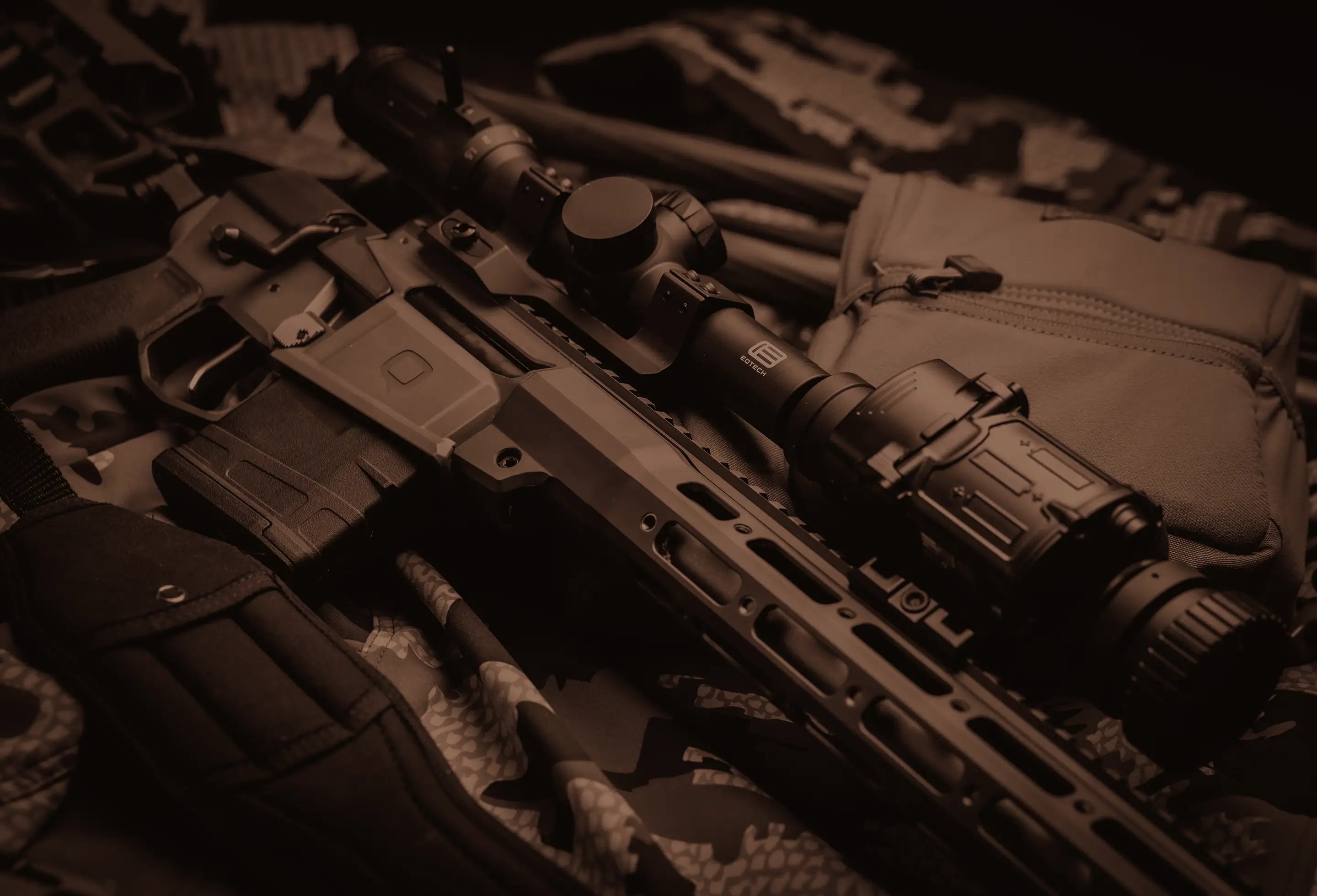 Close-up of a rifle with tactical equipment on a dark background