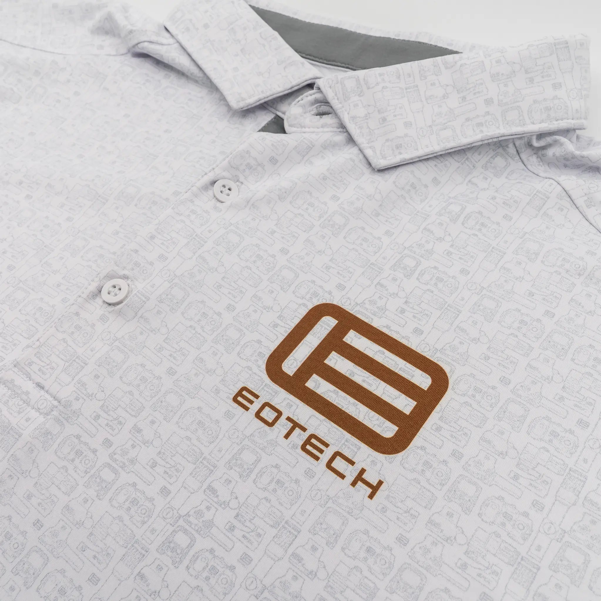 Close-up of a light gray patterned polo shirt with a brown EOTECH logo on the chest.