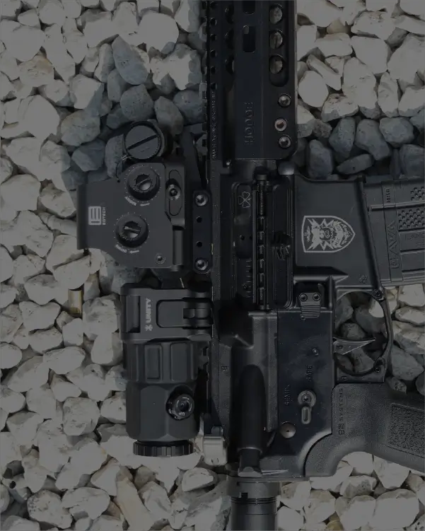 Rifle with an HHS Unity laying on a rocky surface