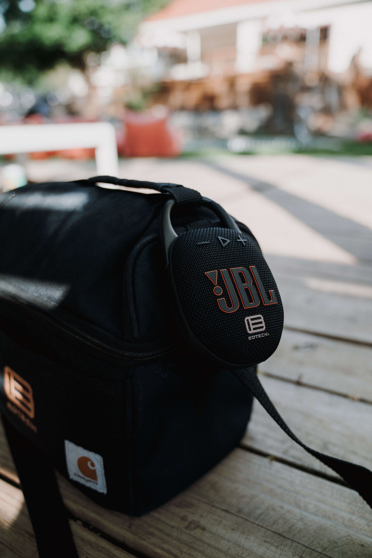 JBL Speaker clipped to a lunch pale, EOTECH logo visible on both