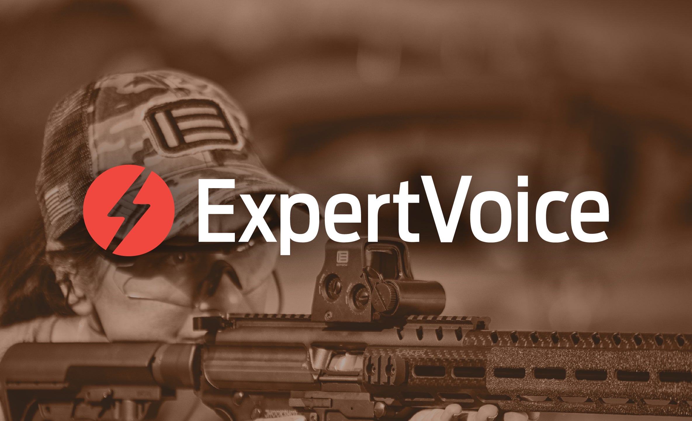 Female in camo hat with rifle and EOTECH HWS optic and 'ExpertVoice' logo in the foreground